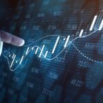 finger pointing to financial chart
